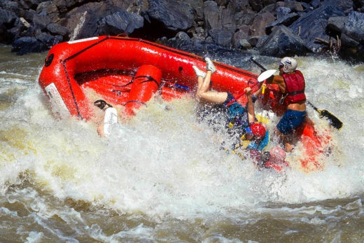 A raft capsizes in 4-Man Hole rapid on the Tugela River, South Africa.